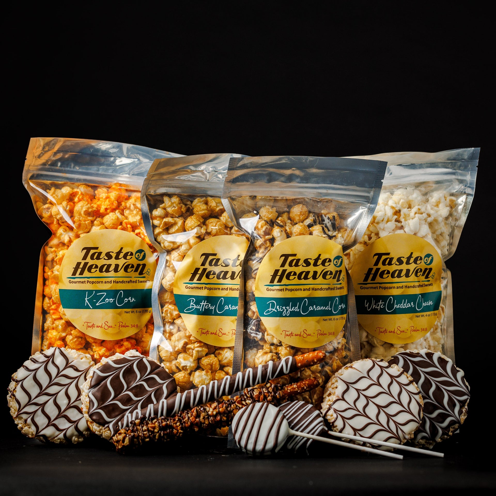 A gift box with various packaged popcorn flavors and confections including caramel corn, white cheddar cheese corn, and chocolate dipped pretzels.