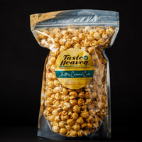 A clear plastic stand-up pouch filled with buttery caramel corn, featuring a round yellow and green Taste Heaven label, set against a solid black background.