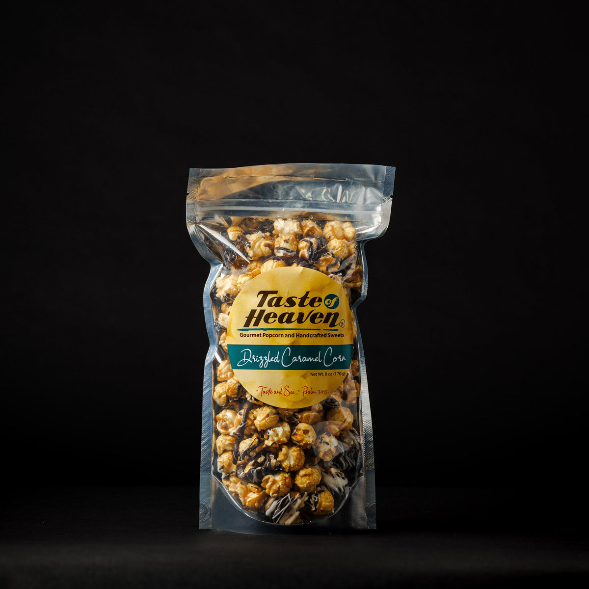 A clear stand-up pouch of Taste of Heaven Drizzled Caramel Corn, standing upright against a solid black background.