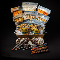 A gift basket containing various packaged snacks including bags of popcorn with different flavors, and trays of chocolate covered treats and crispy snacks.